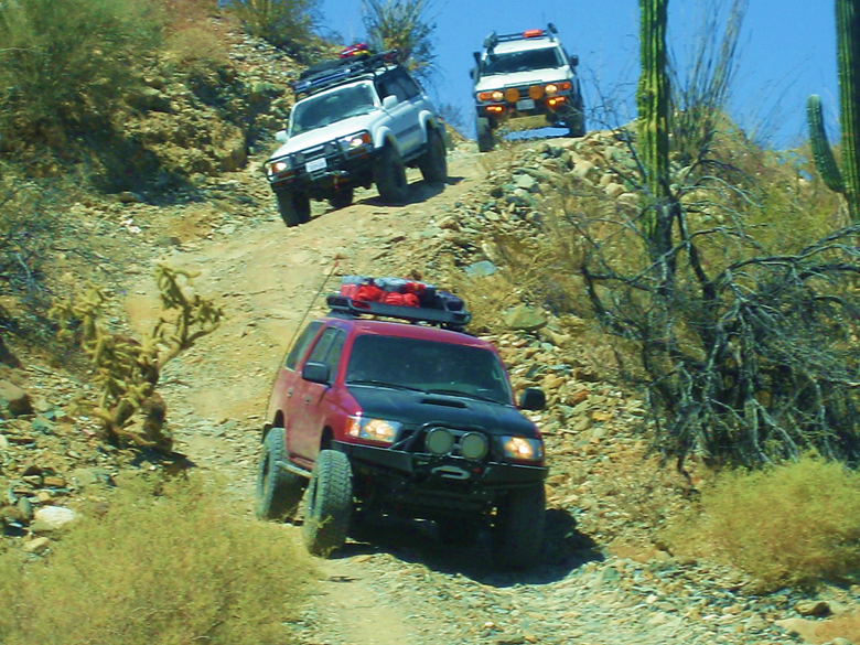 A truck traveling down a dirt road